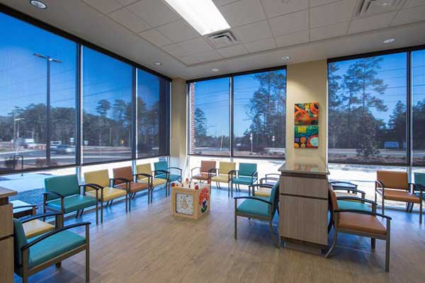 waiting area with large windows and rows of chairs