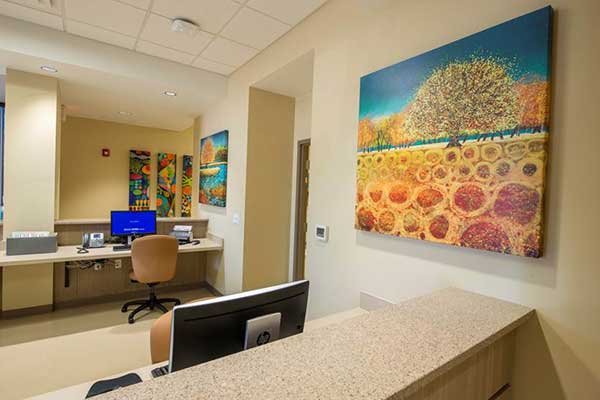 nurses area with brightly color artwork on the wall
